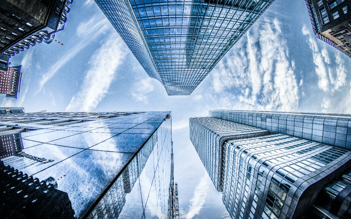 Looking upward at skyscrapers and clouds