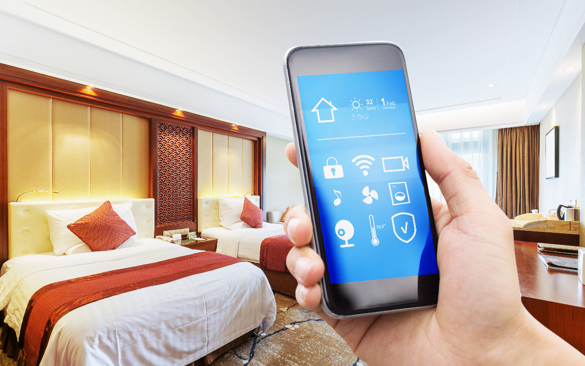 Person holding phone in room to connect to hotel wi-fi.